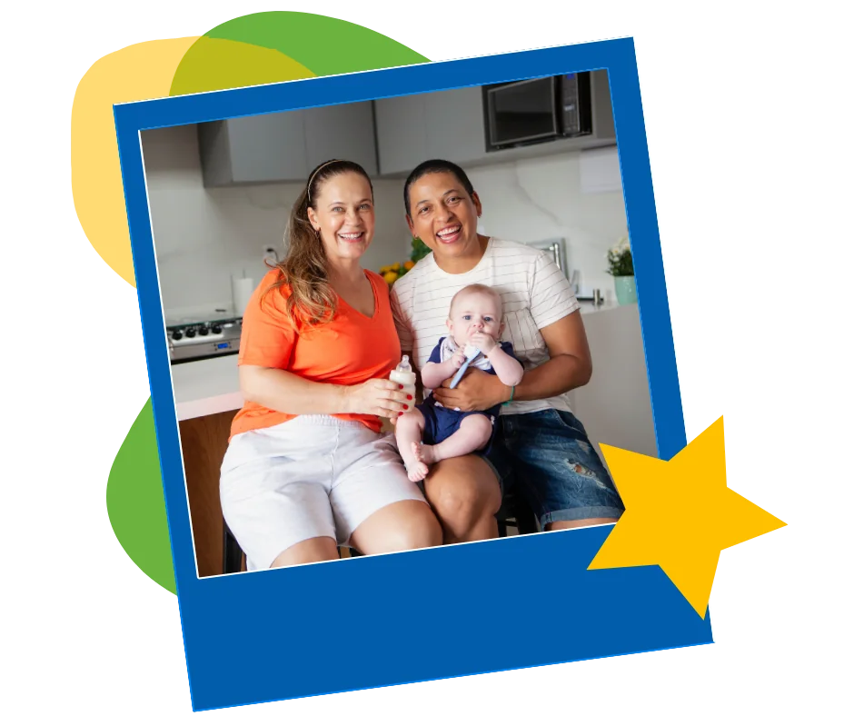adoption-parents-with-baby Two parents holding a baby in a kitchen