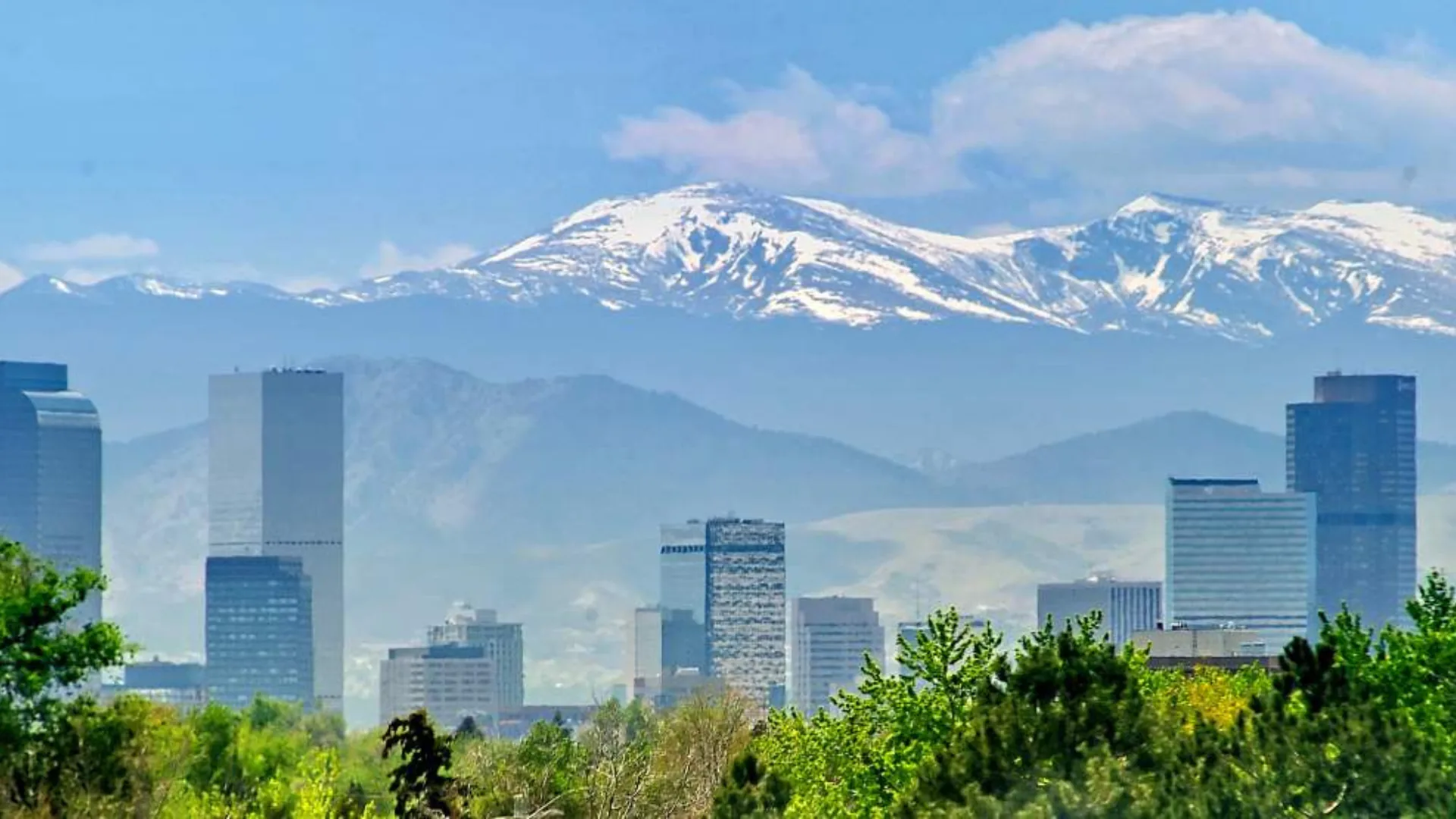 Denver skyline with the snow-capped Front Range behind it