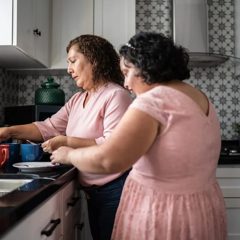 ariel-home-get-involved-residential-provider-square Two women making coffee together in a home kitchen