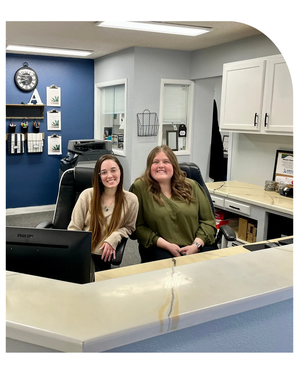 Two staff members at the front desk of Ariel’s Colorado Springs office