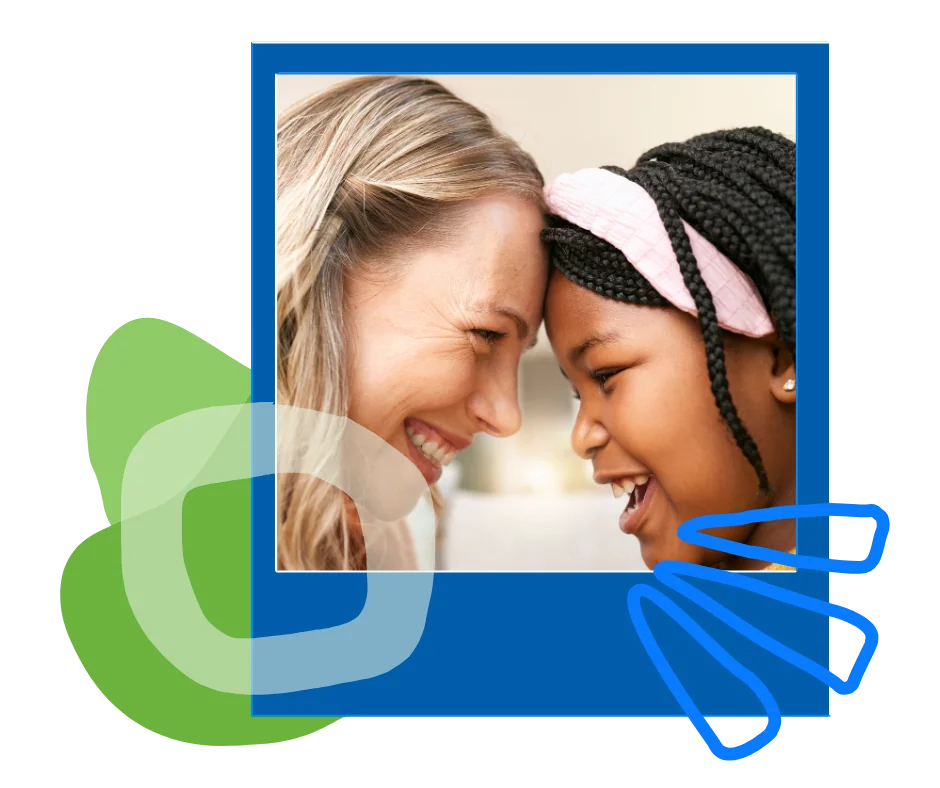 A woman and a young girl touching foreheads and laughing