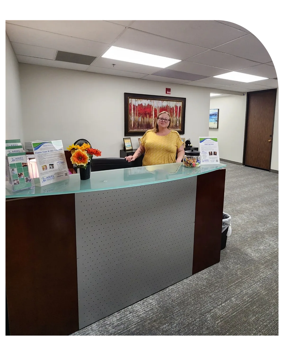 Staff member at the reception desk of Ariel’s Pueblo office