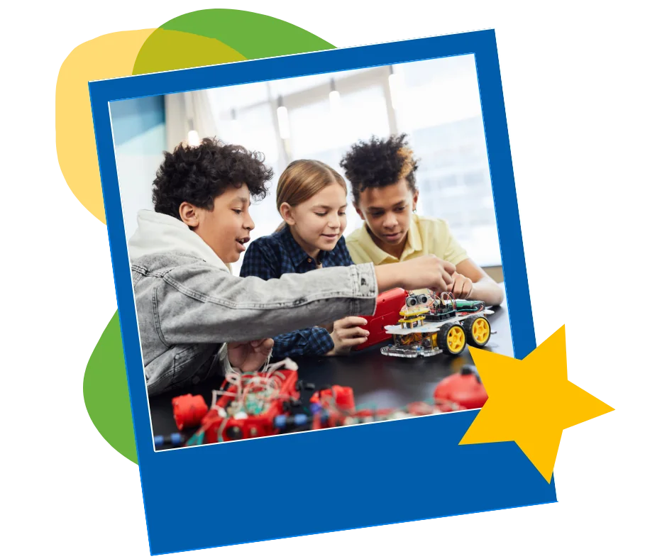 Three kids building a small robot at a table